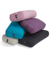 A collection of Everyday Yoga Bolsters in various colors, including kale, purple, and teal, designed for enhancing yoga practice. These rectangular bolsters provide support and comfort during poses, ensuring a more effective and relaxing session. Ideal for yogis seeking quality