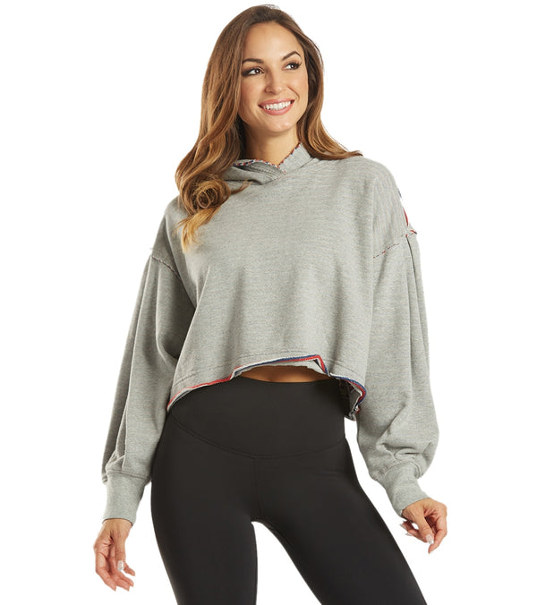 Free People Women's Yoga Hoodie in Heather Gray, designed for comfort and style during yoga sessions. This cropped hoodie features a relaxed fit with a soft fabric, ideal for layering over activewear. Perfect for enhancing your yoga wardrobe with a trendy and functional piece.