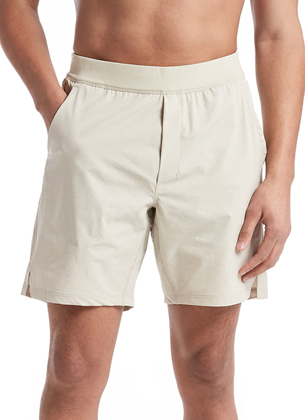 Public Rec Men's Yoga Shorts in beige, designed for comfort and flexibility during yoga sessions. These lightweight shorts feature an elastic waistband and side pockets for convenience. Ideal for enhancing mobility and style in your workout routine.