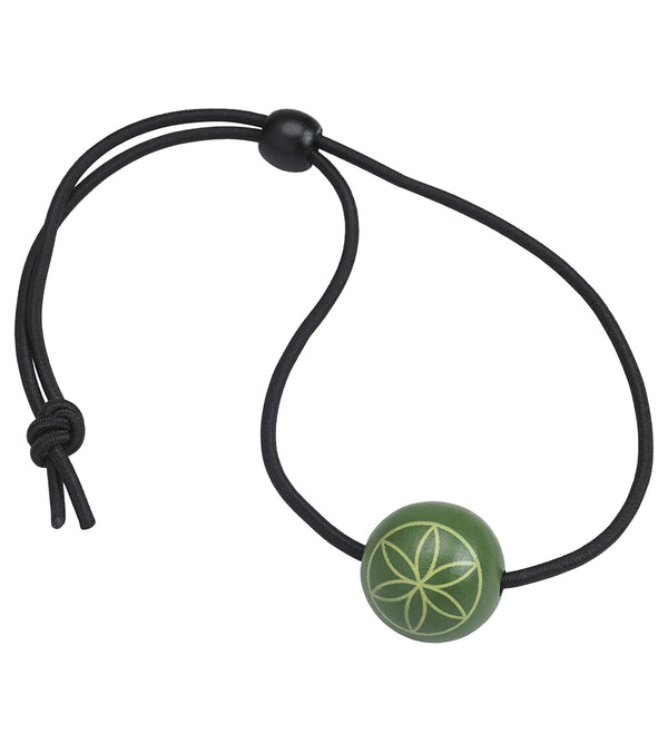 Gaiam yoga mat sling featuring a black adjustable cord with a green bead, designed for easy carrying of yoga mats. The bead has a decorative pattern, adding style to this practical yoga accessory. Ideal for yoga enthusiasts seeking a convenient and stylish way to