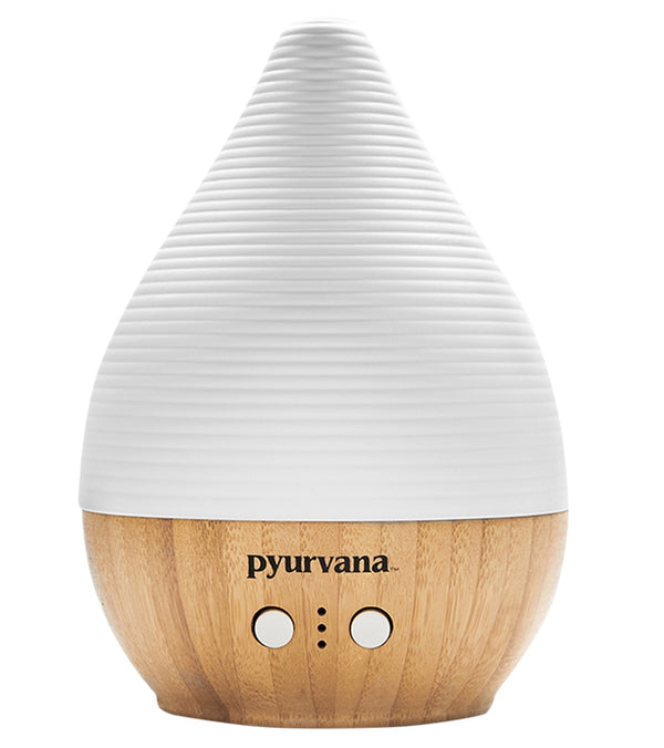 Pyurvana aromatherapy diffuser in a sleek white and brown design, ideal for enhancing yoga sessions with calming scents. The diffuser features a textured white top and a smooth wooden base, combining functionality with aesthetic appeal. Perfect for creating a tranquil environment, this