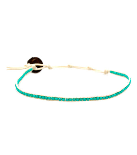 Lotus and Luna yoga bracelet featuring turquoise beads on a delicate string, ideal for enhancing your yoga practice. This handcrafted accessory combines style and spirituality, perfect for those seeking a meaningful addition to their yoga routine.