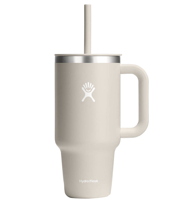 Hydroflask stainless steel water bottle in an oat color, featuring a durable handle and straw lid, ideal for yoga enthusiasts. The sleek design ensures temperature retention for both hot and cold beverages. Perfect for maintaining hydration during yoga sessions.